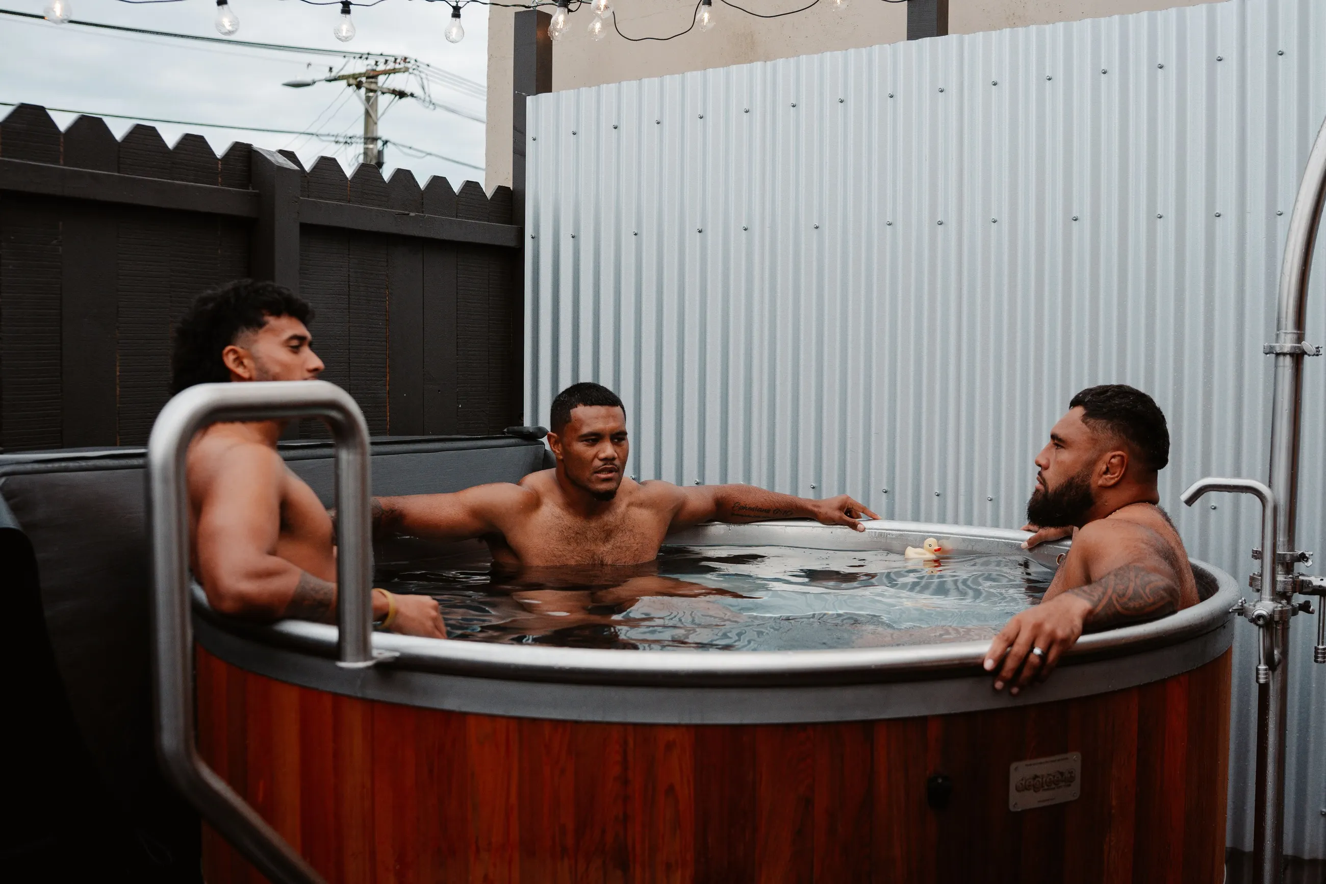 Three members talking it out in the ice bath after training.