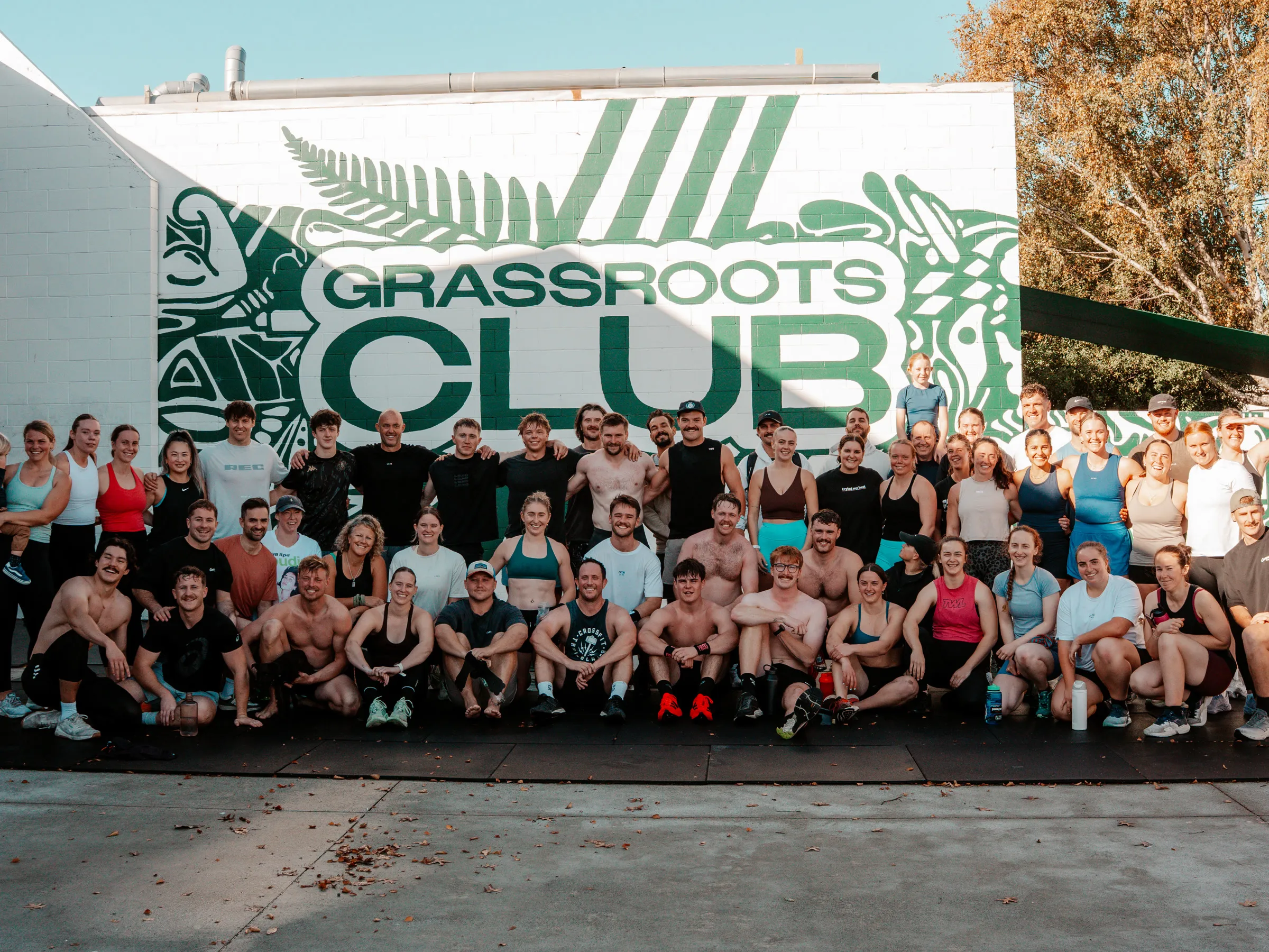 The whole Grassroots Club crew together under the big club mural.