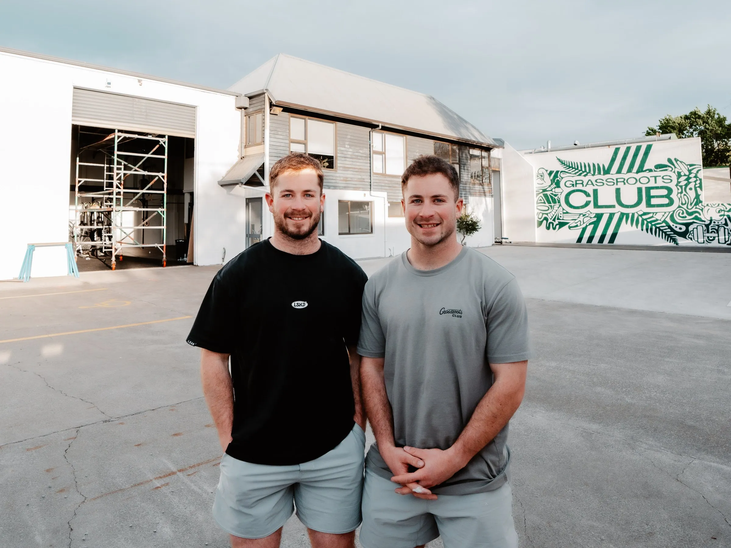 Morgan and Kaden Gibbons, twin founders, outside the Grassroots Club building.