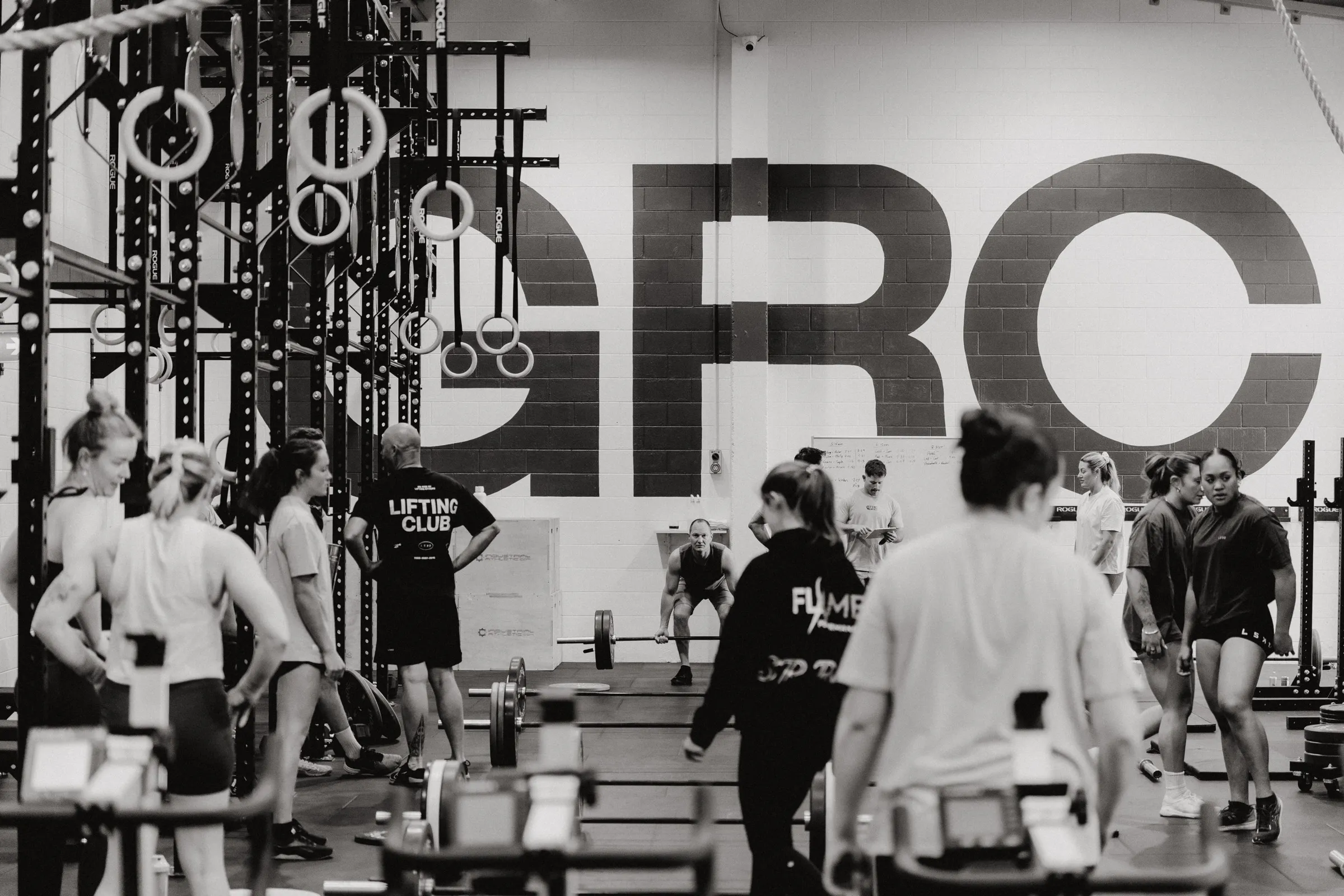A full CrossFit class on the floor at Grassroots Club, the big GRC wall behind them.