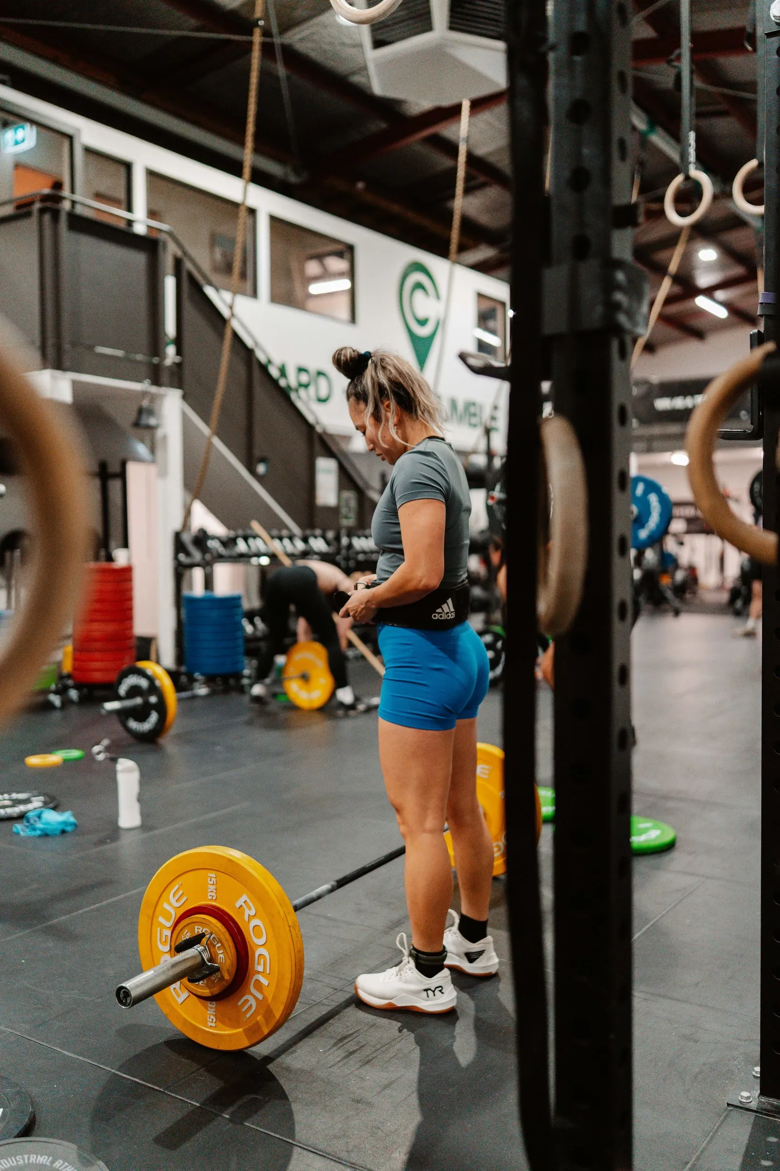 A lifter setting up over a loaded barbell in Lifting.